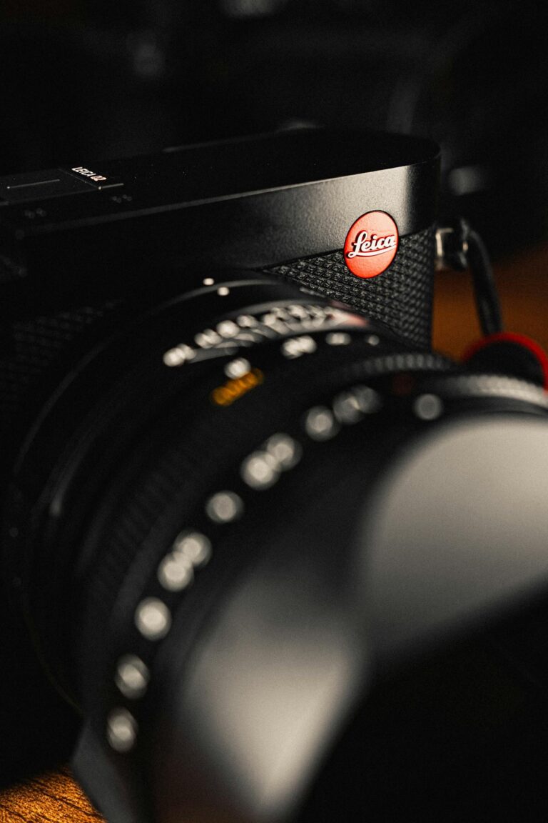 Detailed view of a camera lens showcasing the brand emblem and intricate design.